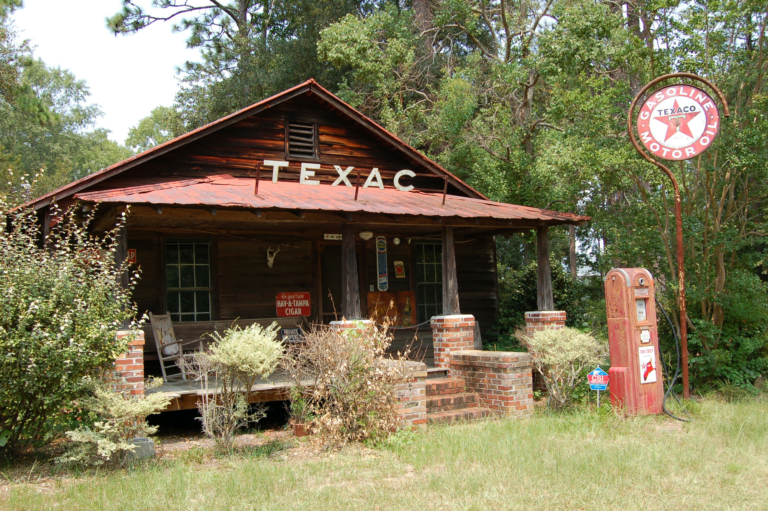 Old texas gas station with vintage pump and sign.