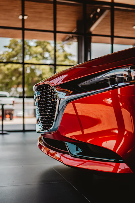 Red car grille and headlight in showroom