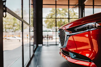 Red car grille and headlight in showroom