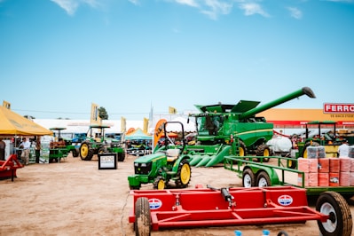 Green tractors and combine harvester at outdoor exhibition