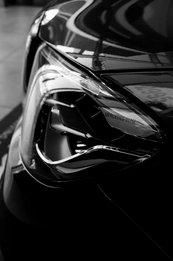 Close-up of a black car's modern headlight