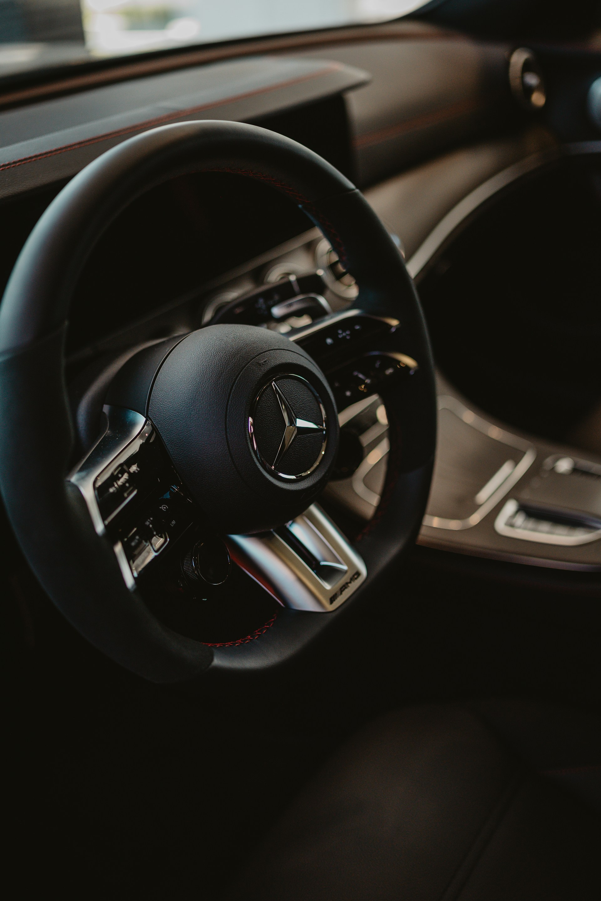 Close-up of a modern car steering wheel with logo