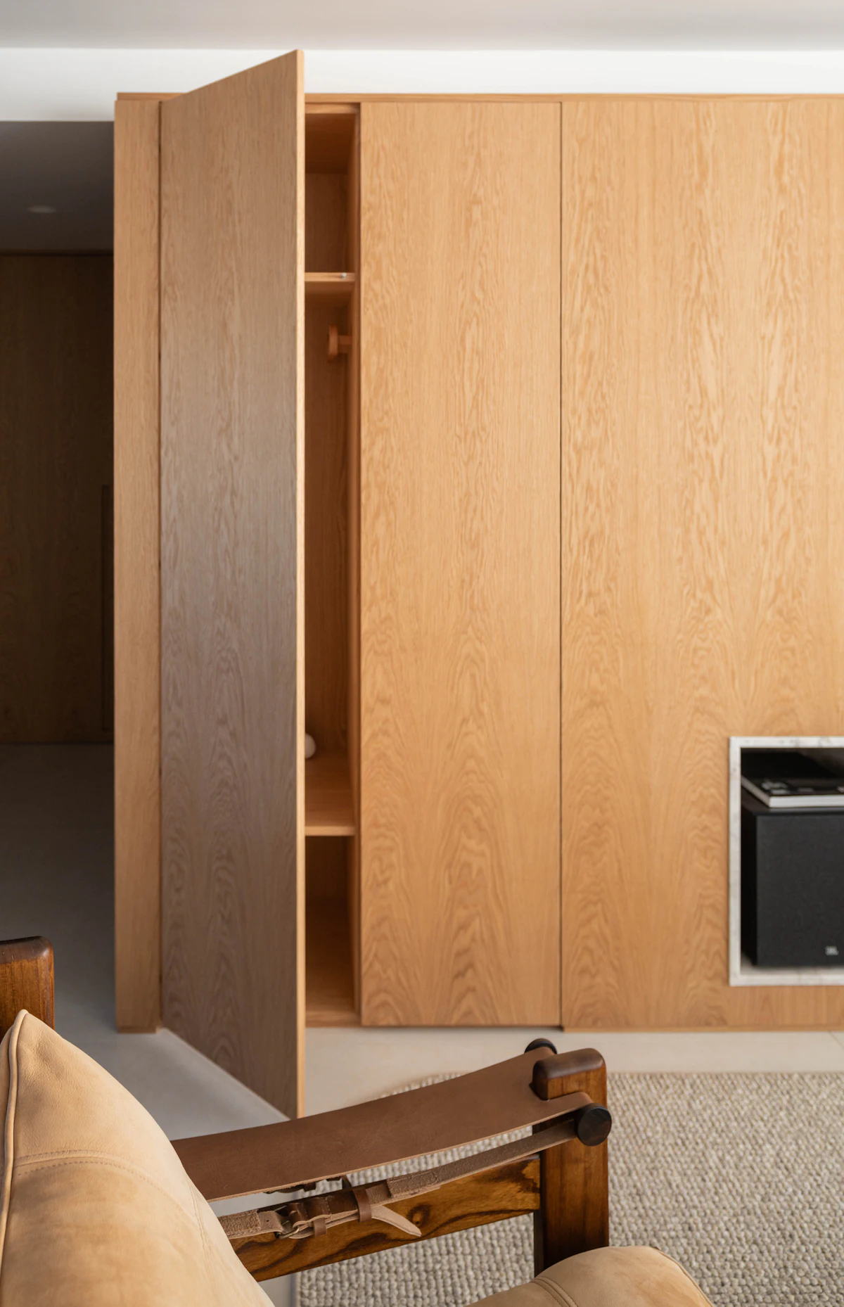 Armario de madera a medida con puertas abiertas y estantes interiores
