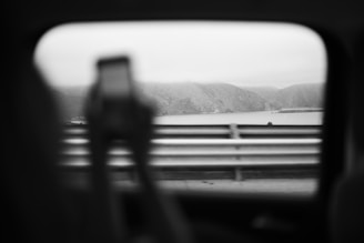View through car window of person holding phone