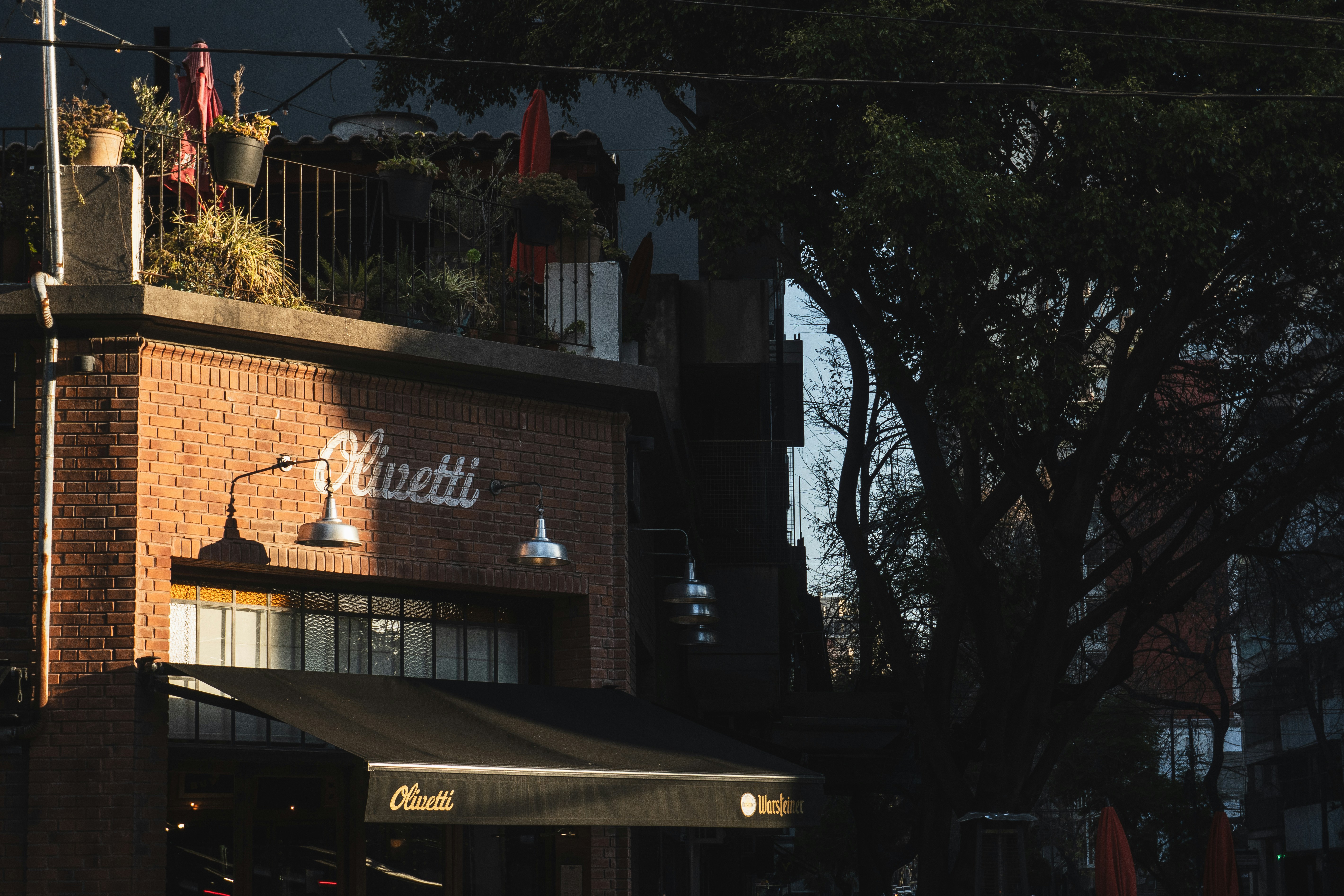 Brick building with outdoor seating and awning