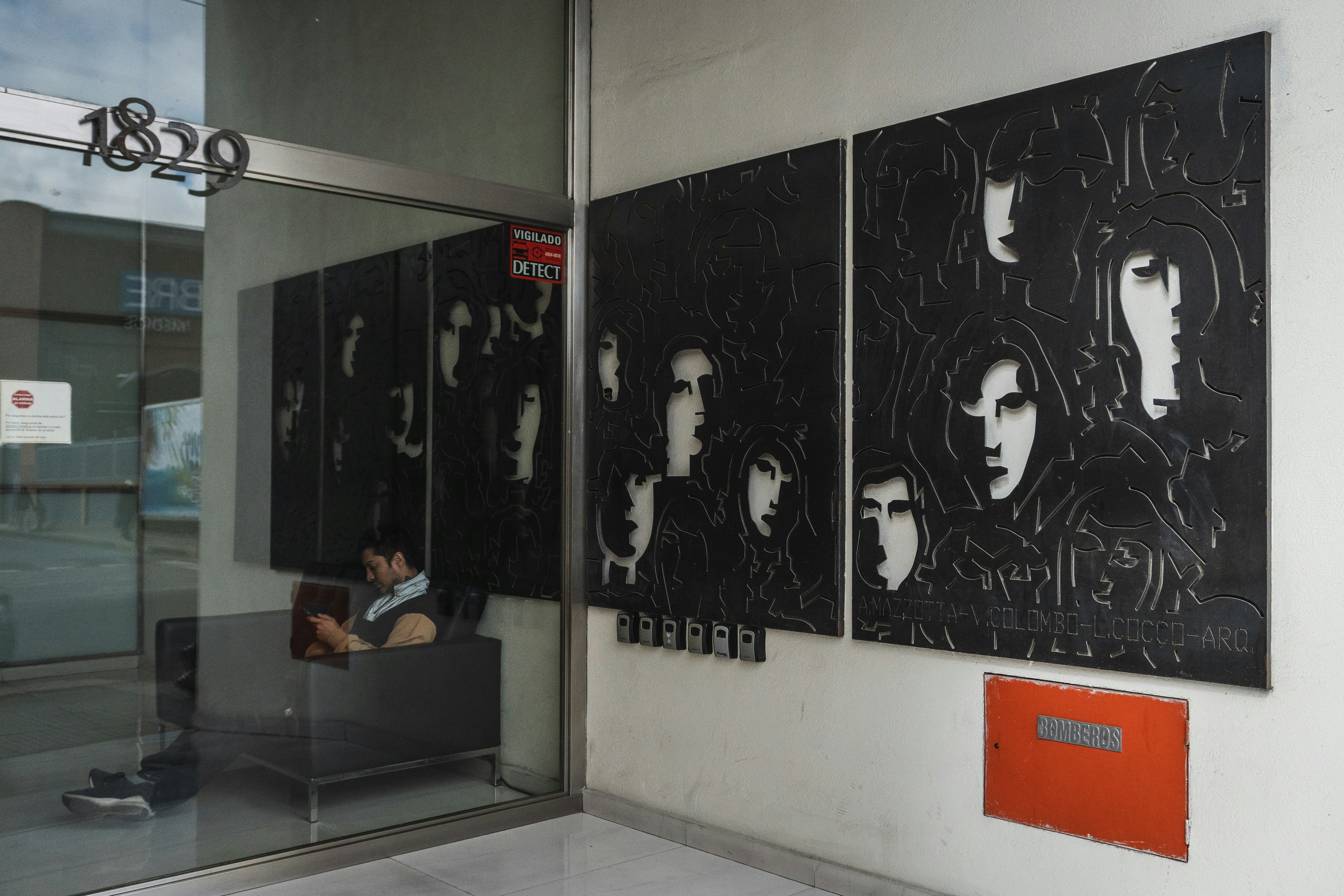 Triptych artwork of faces on a wall