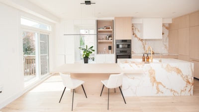 Modern kitchen with marble island and dining area