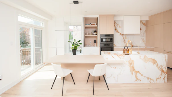 Modern kitchen with marble island and dining area