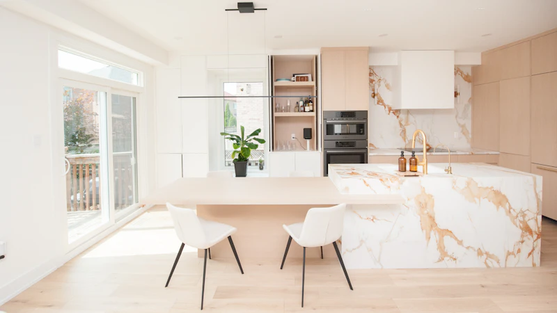 Modern renovated kitchen with marble island and dining area