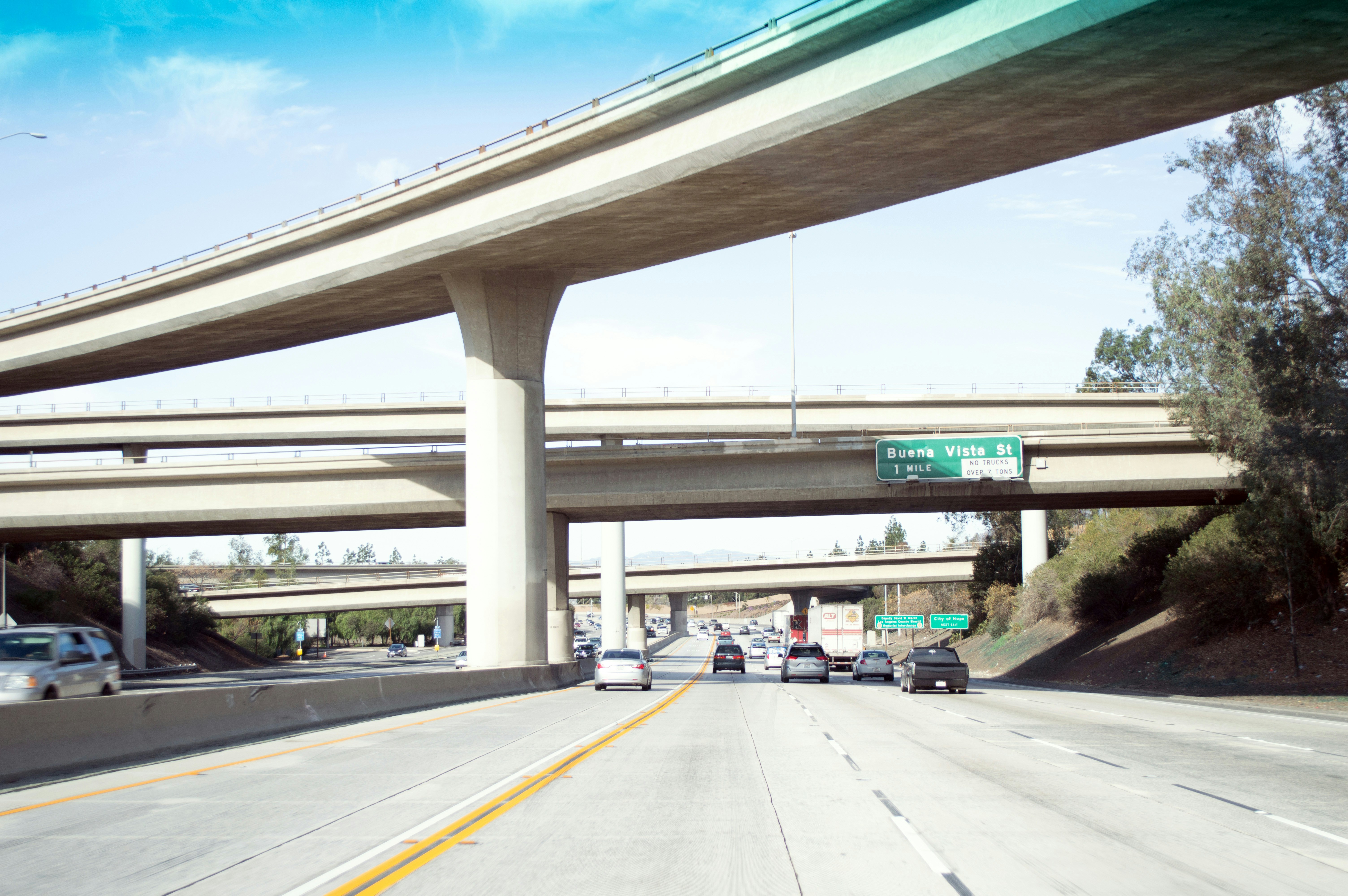 Overpass and highway traffic under a clear sky