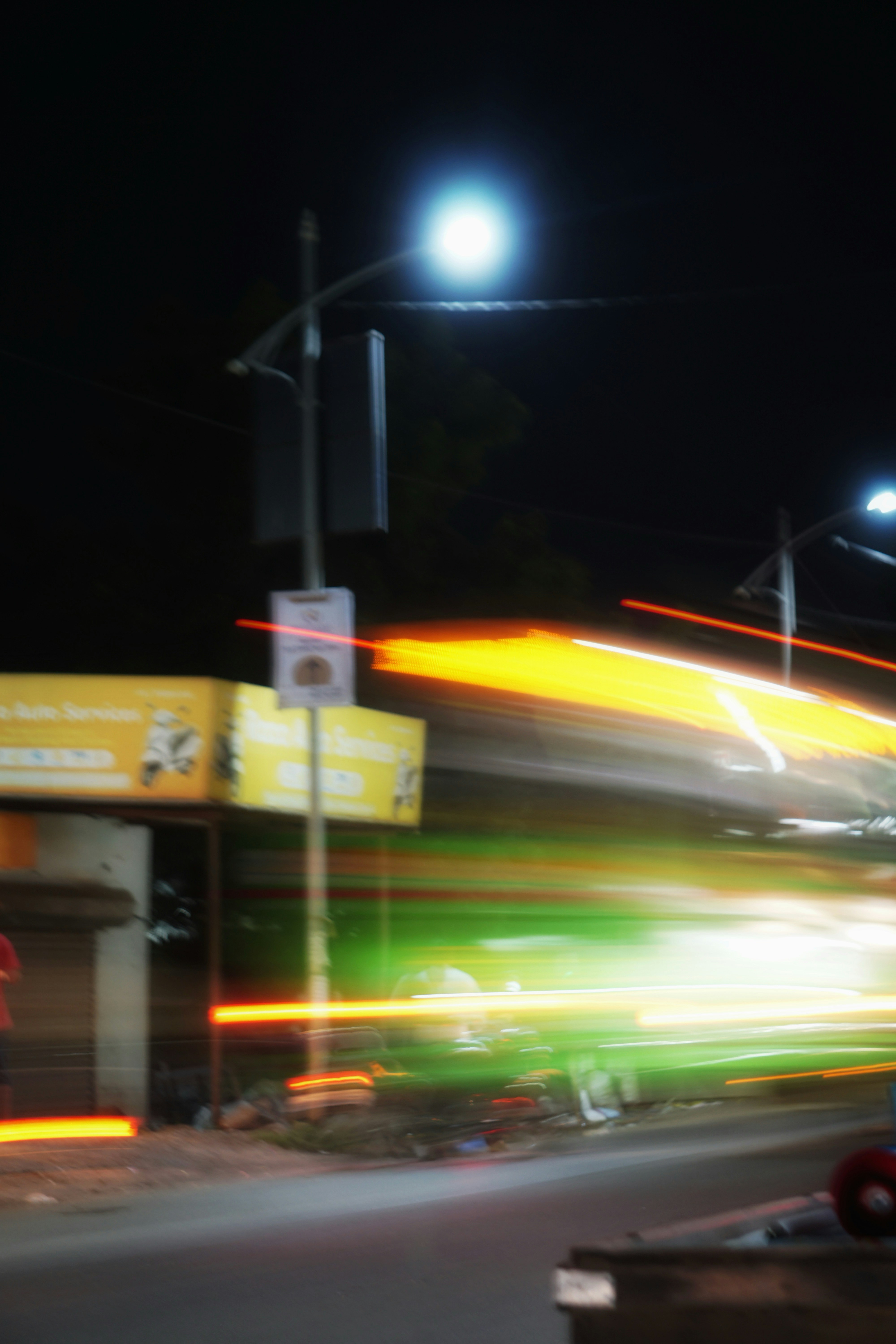 Rayas de luz borrosas de vehículos en movimiento por la noche