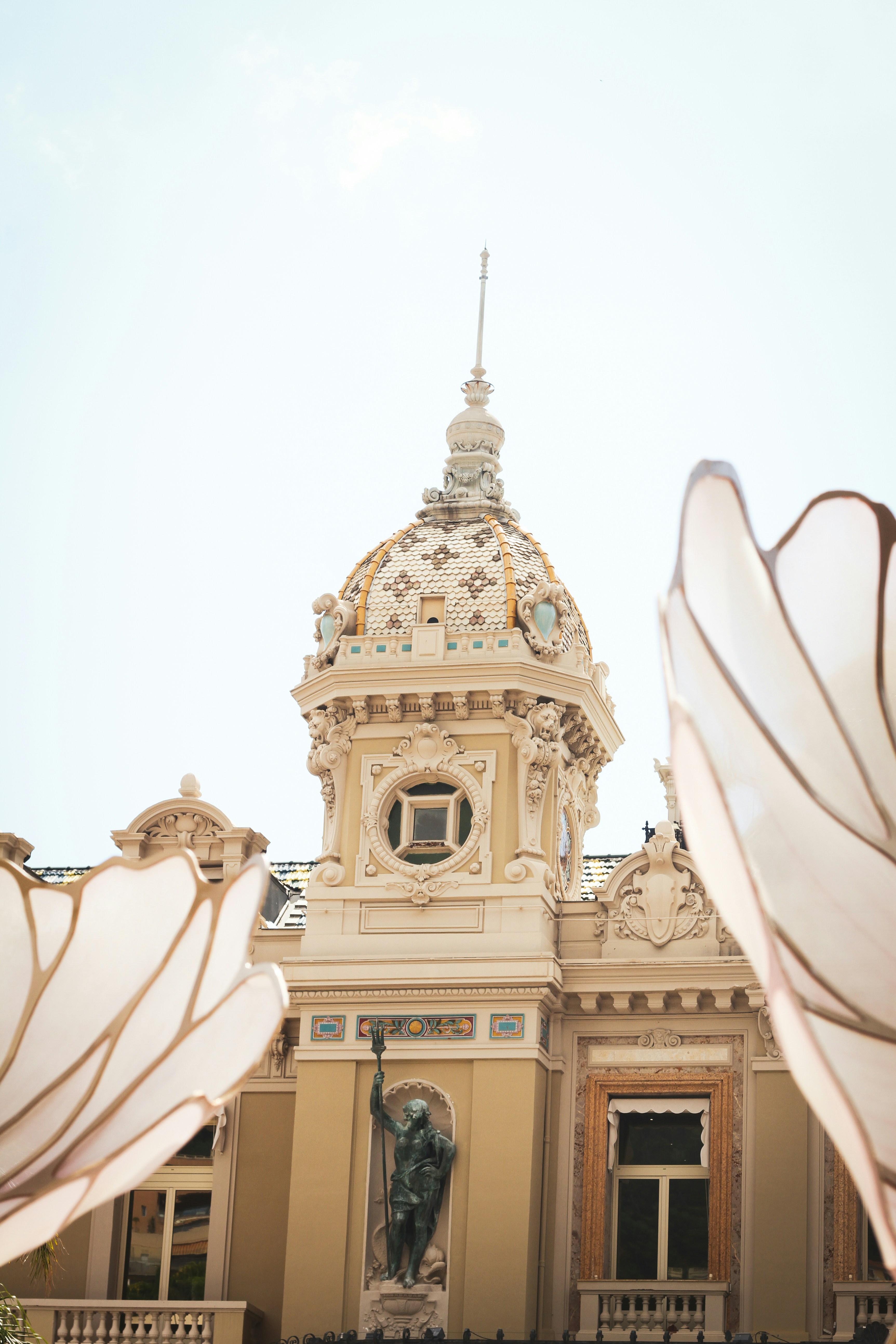 Ornate building with a dome and statue
