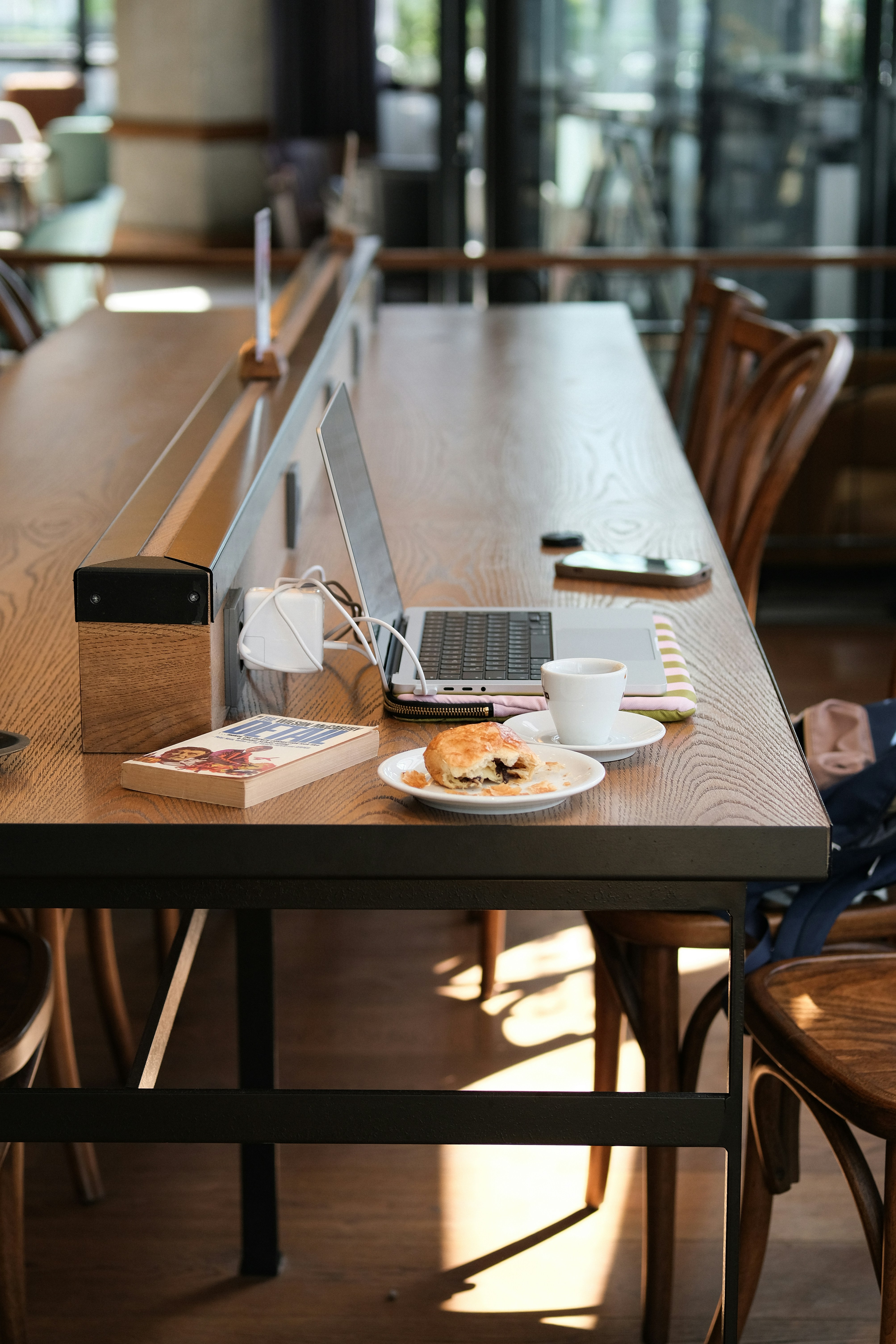 Laptop and pastry on a wooden table