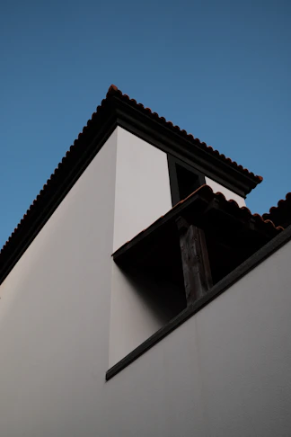White building corner against a clear blue sky