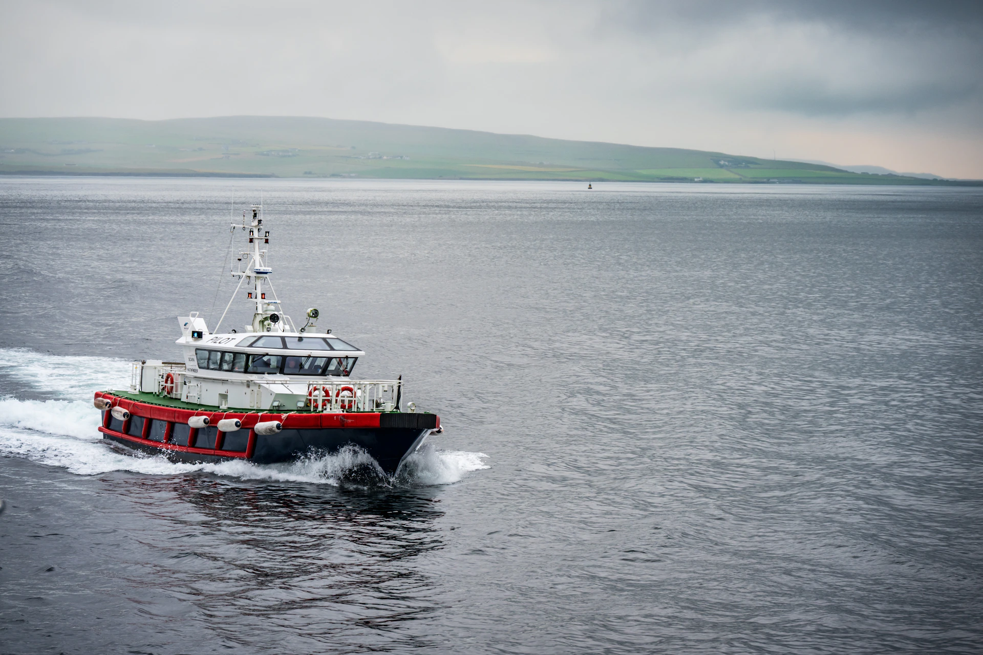 A utility boat travels across choppy water