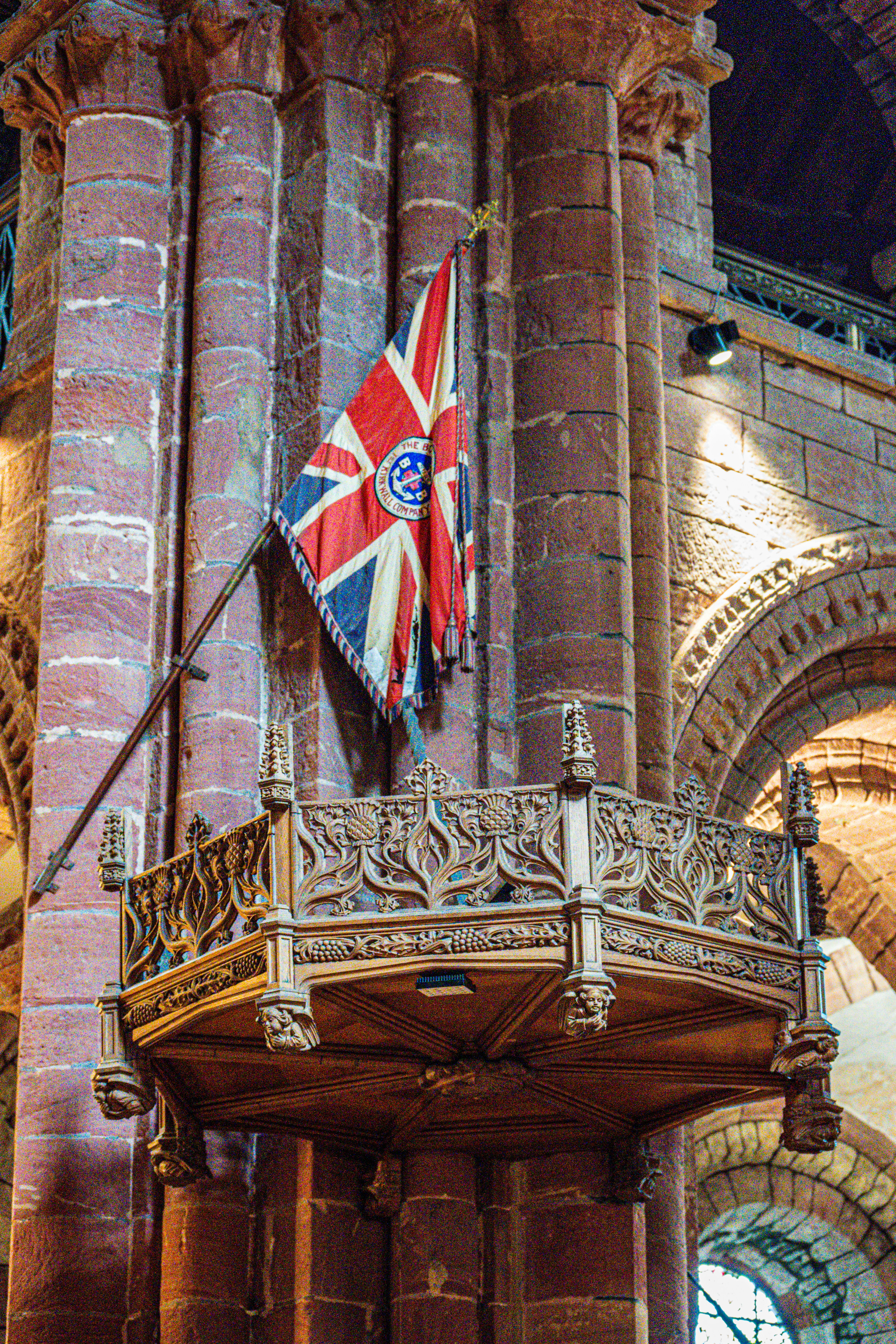 Ornate wooden pulpit with union jack flag inside church