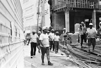 Construction workers walk at a busy building site.