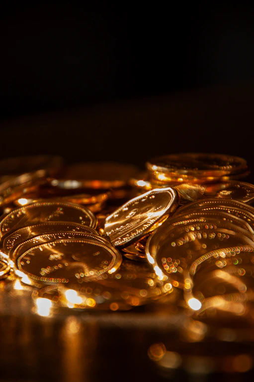 A pile of shiny gold coins in soft light