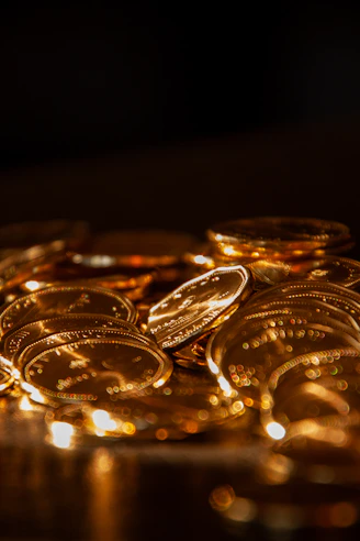 A pile of shiny gold coins in soft light