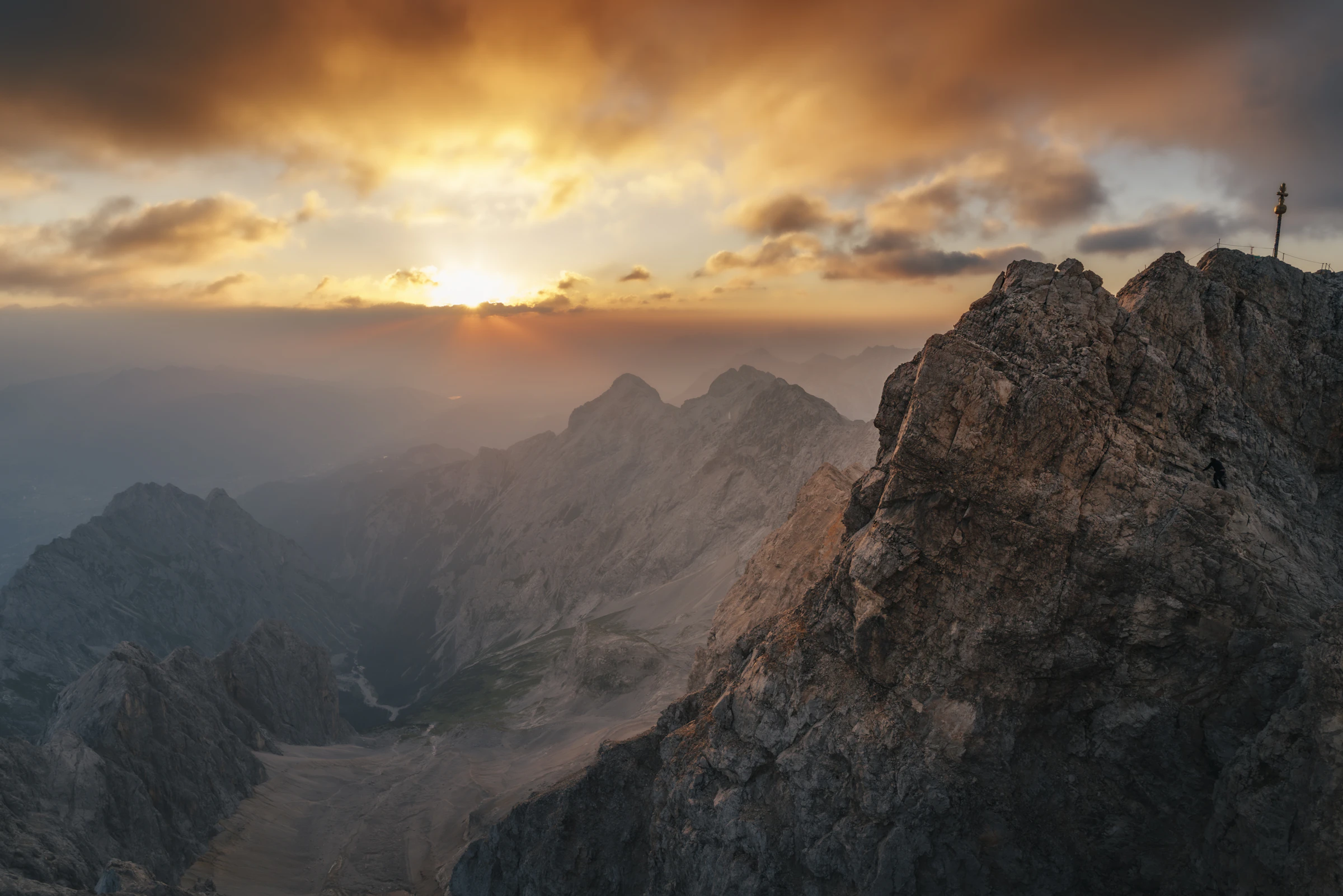Mountain summit above the clouds at sunrise