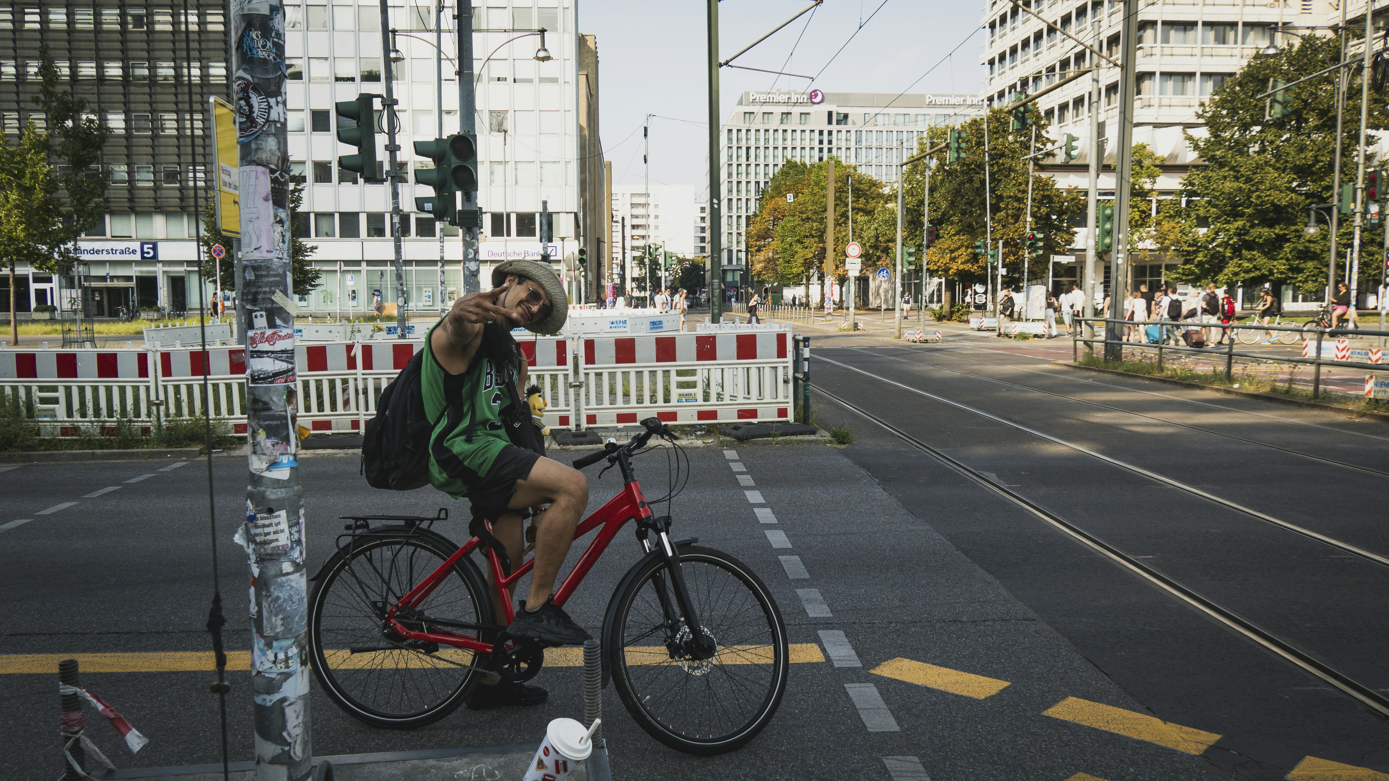 Man on bicycle pauses at city intersection