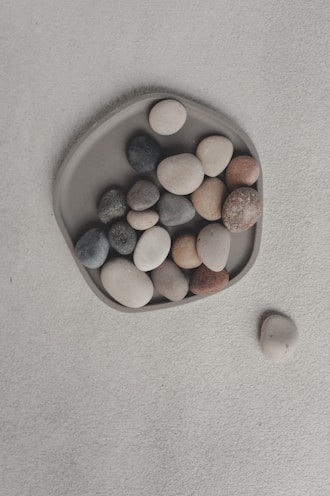 Smooth stones arranged on a gray dish