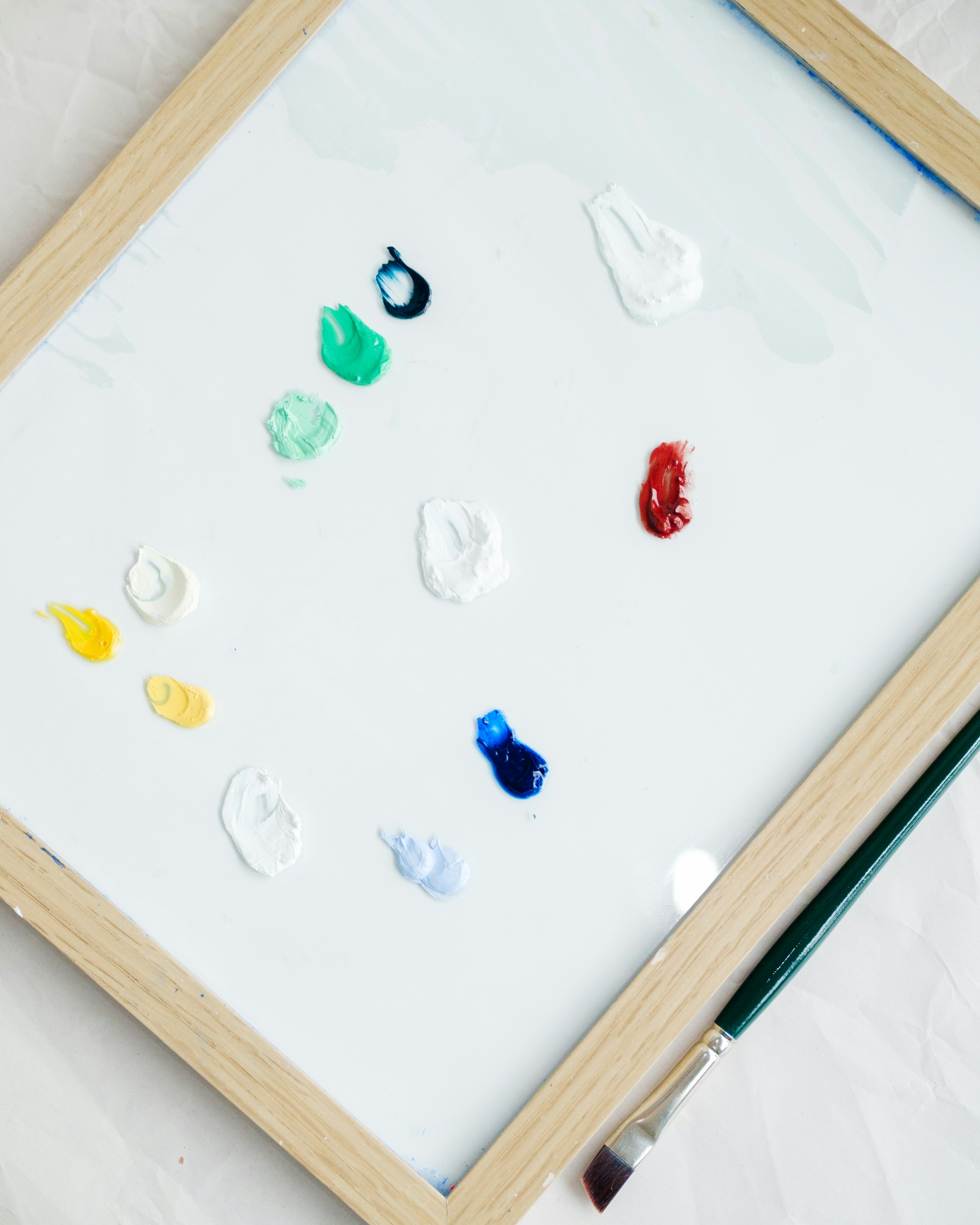 Paint palette with various colors and a brush