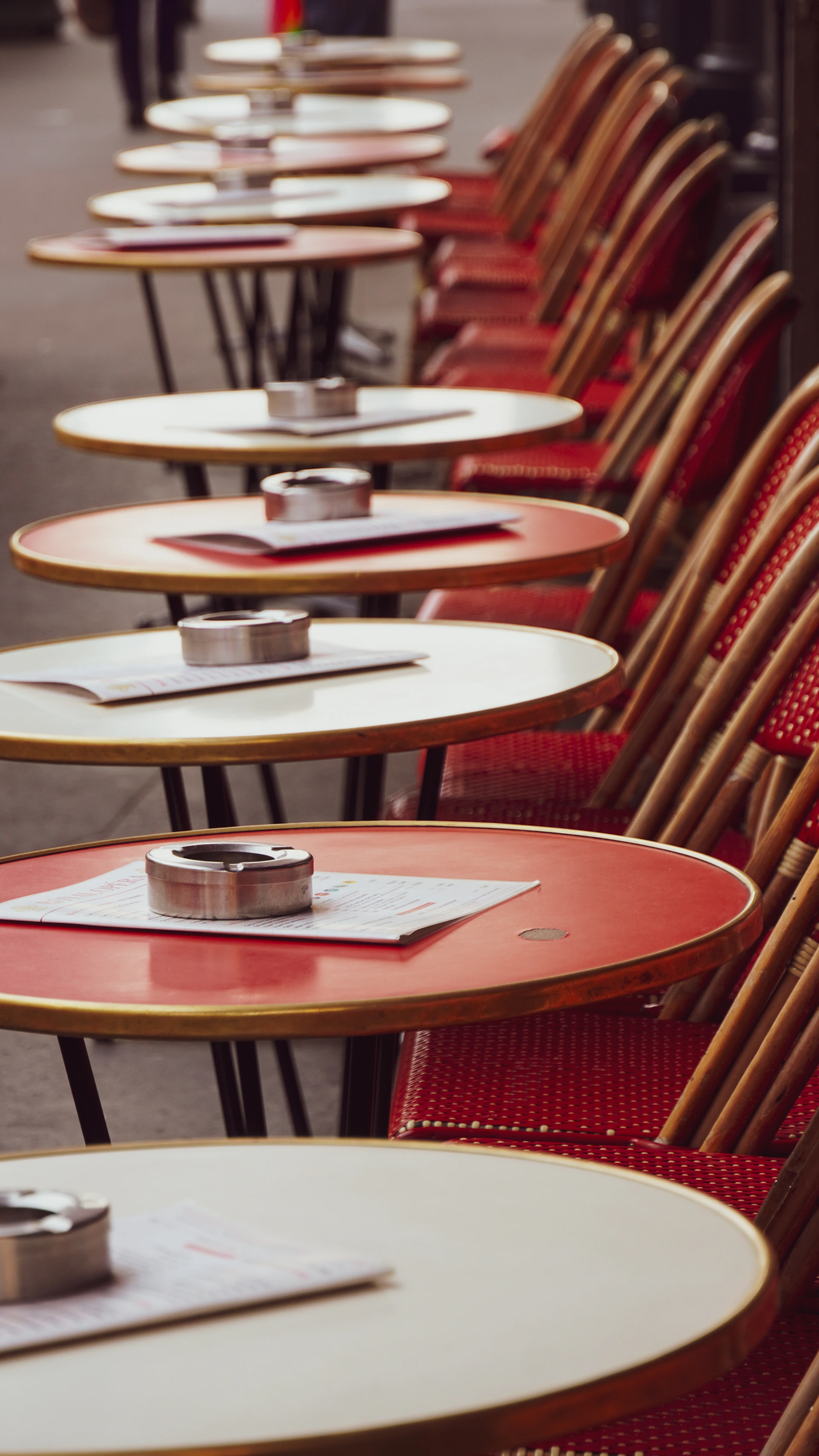 Outdoor cafe tables and chairs in a row.