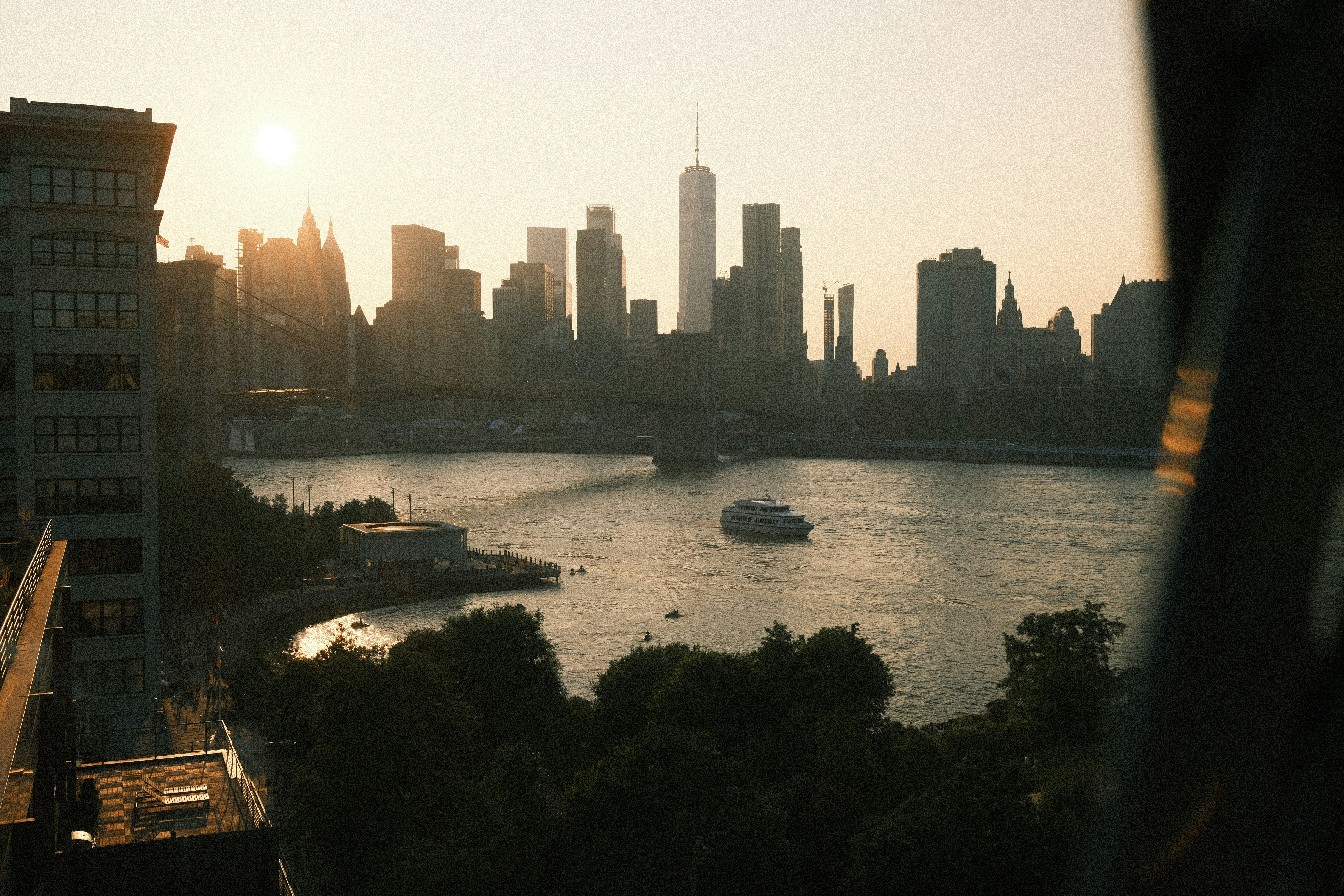 New york city skyline at sunset with a boat on the water. photo – Free ...