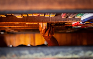Hand reaching for a book on a shelf