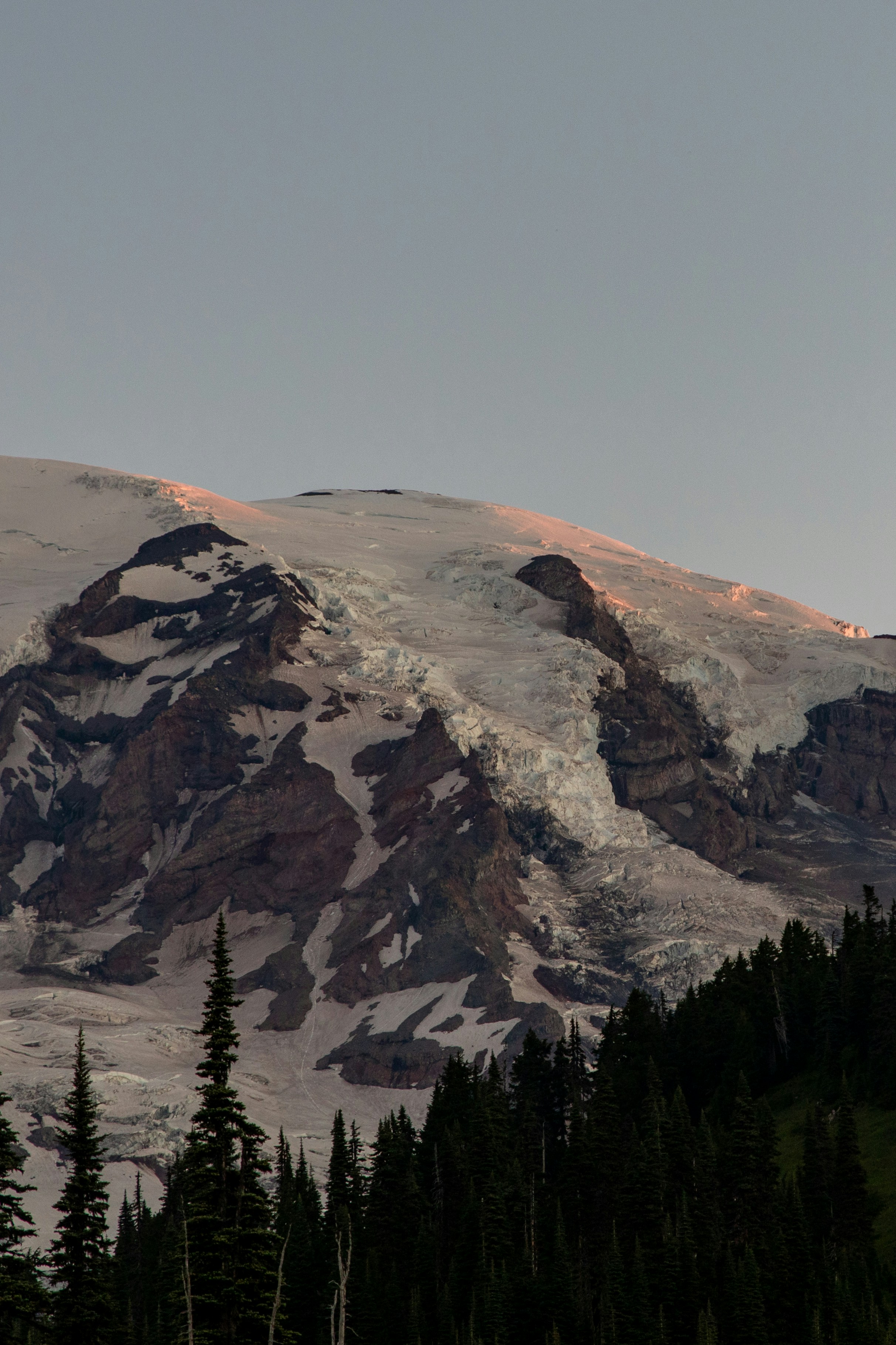 Snow-capped mountain peak touched by golden hour light