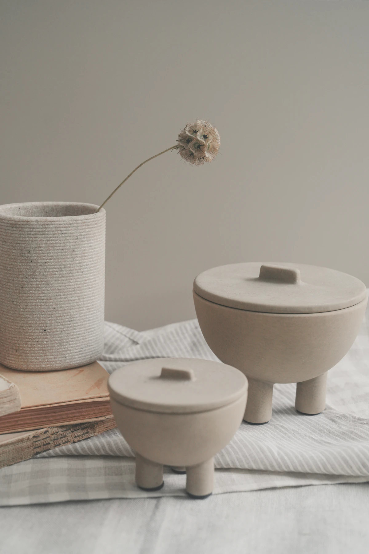 Sculptural ceramic jars arranged on folded linen