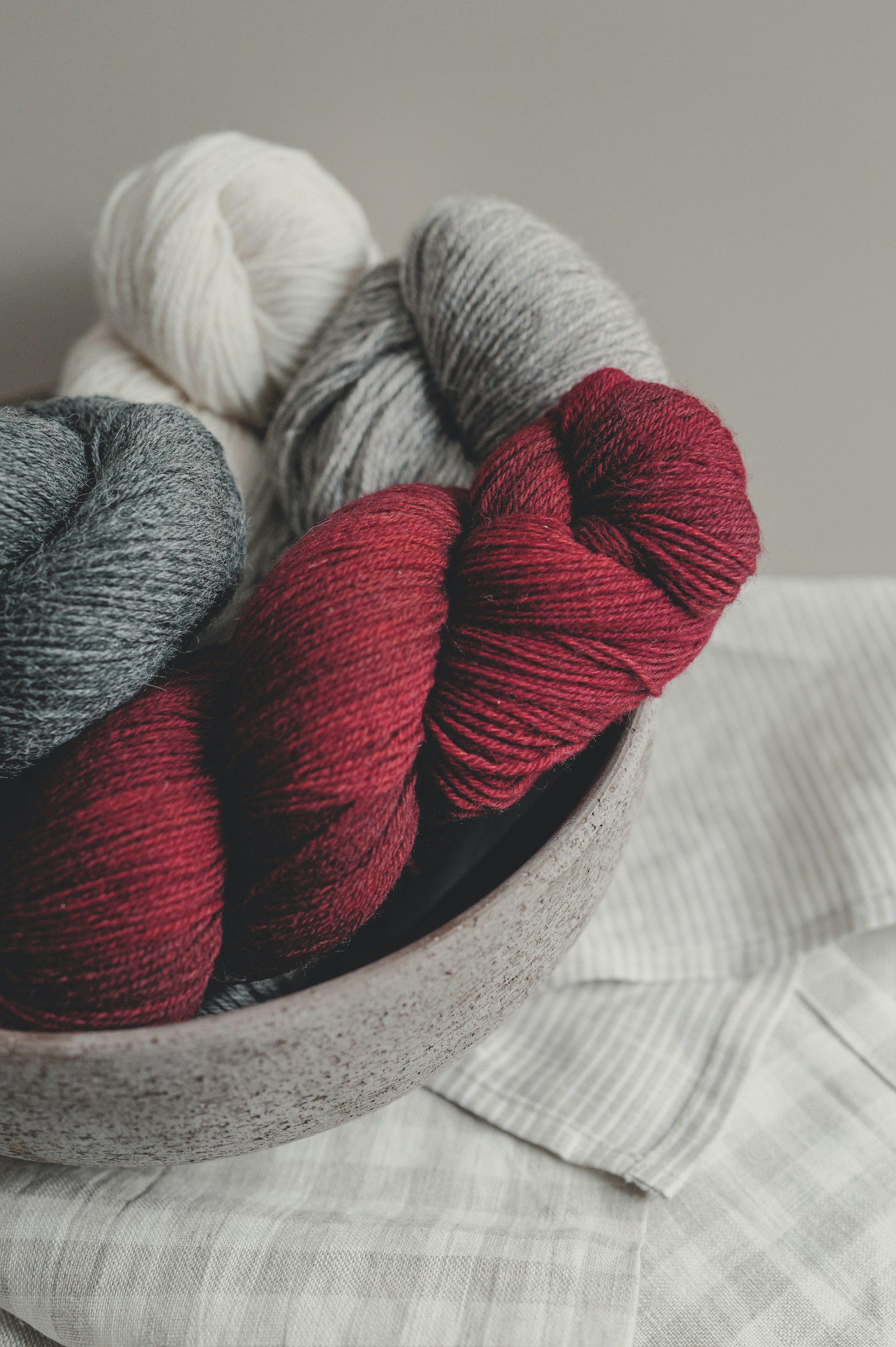 Bowl of red, grey, and white yarn