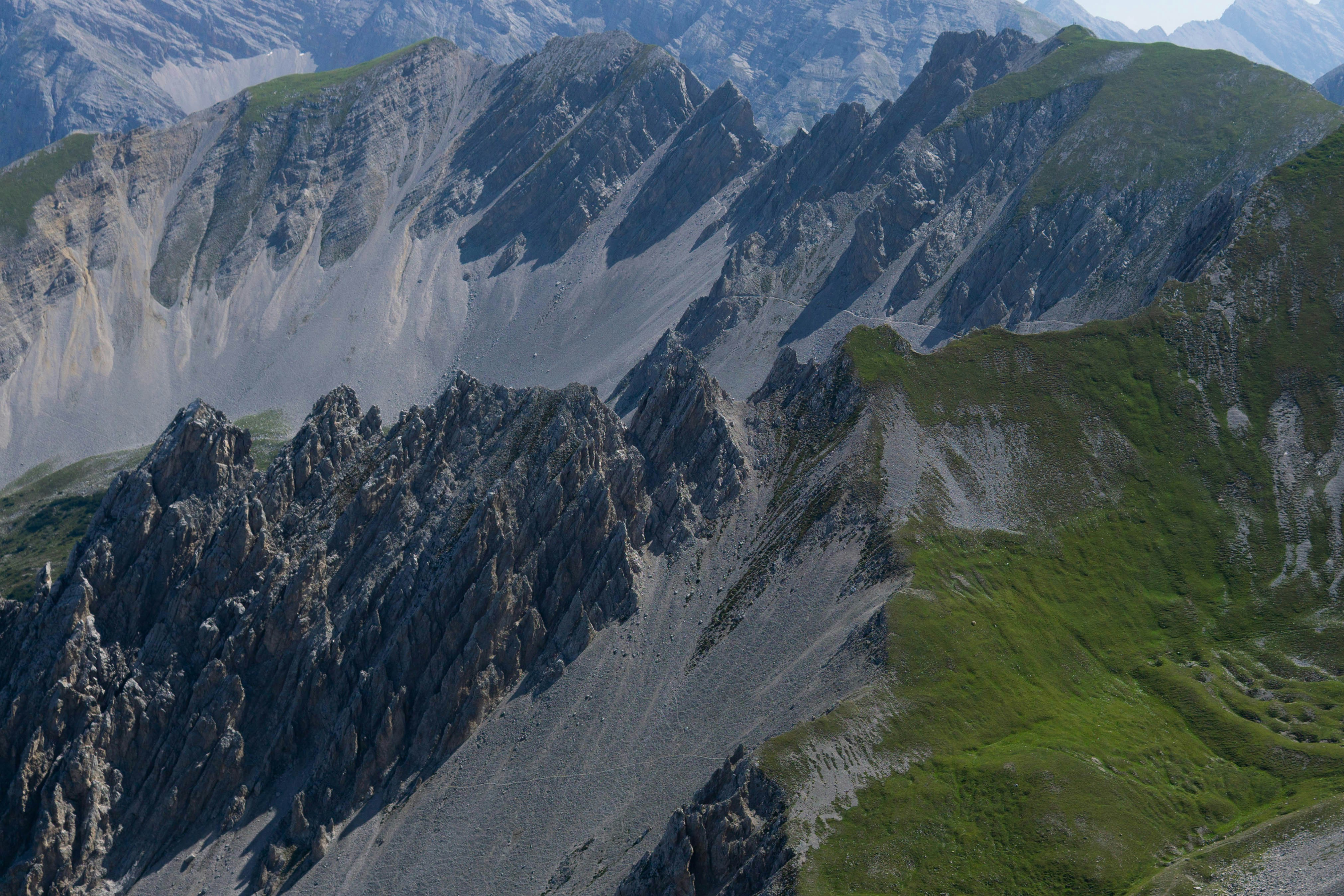 Jagged mountain ridges with green grass slopes photo – Free Wallpaper ...