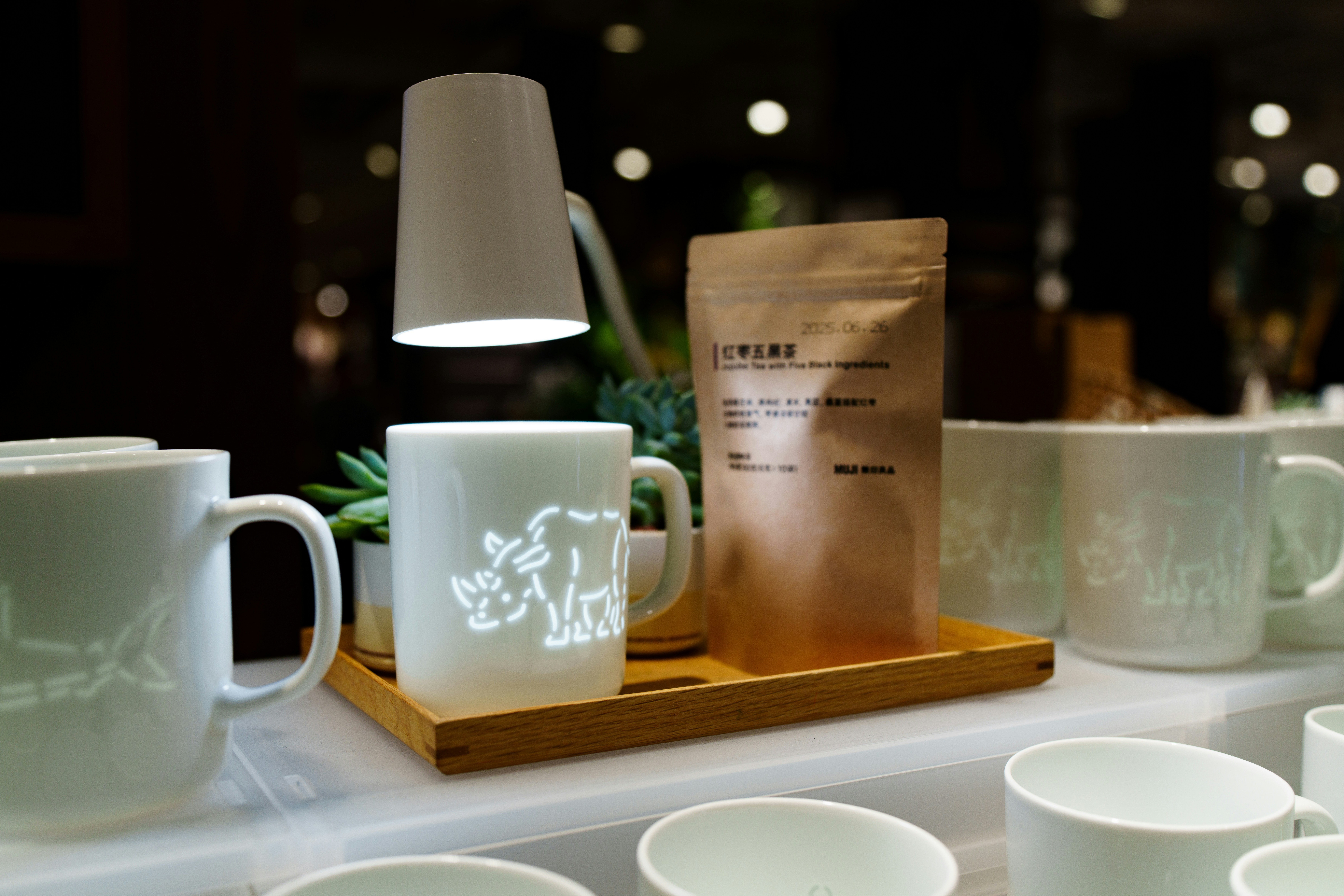 Coffee mugs and bag of coffee beans on display