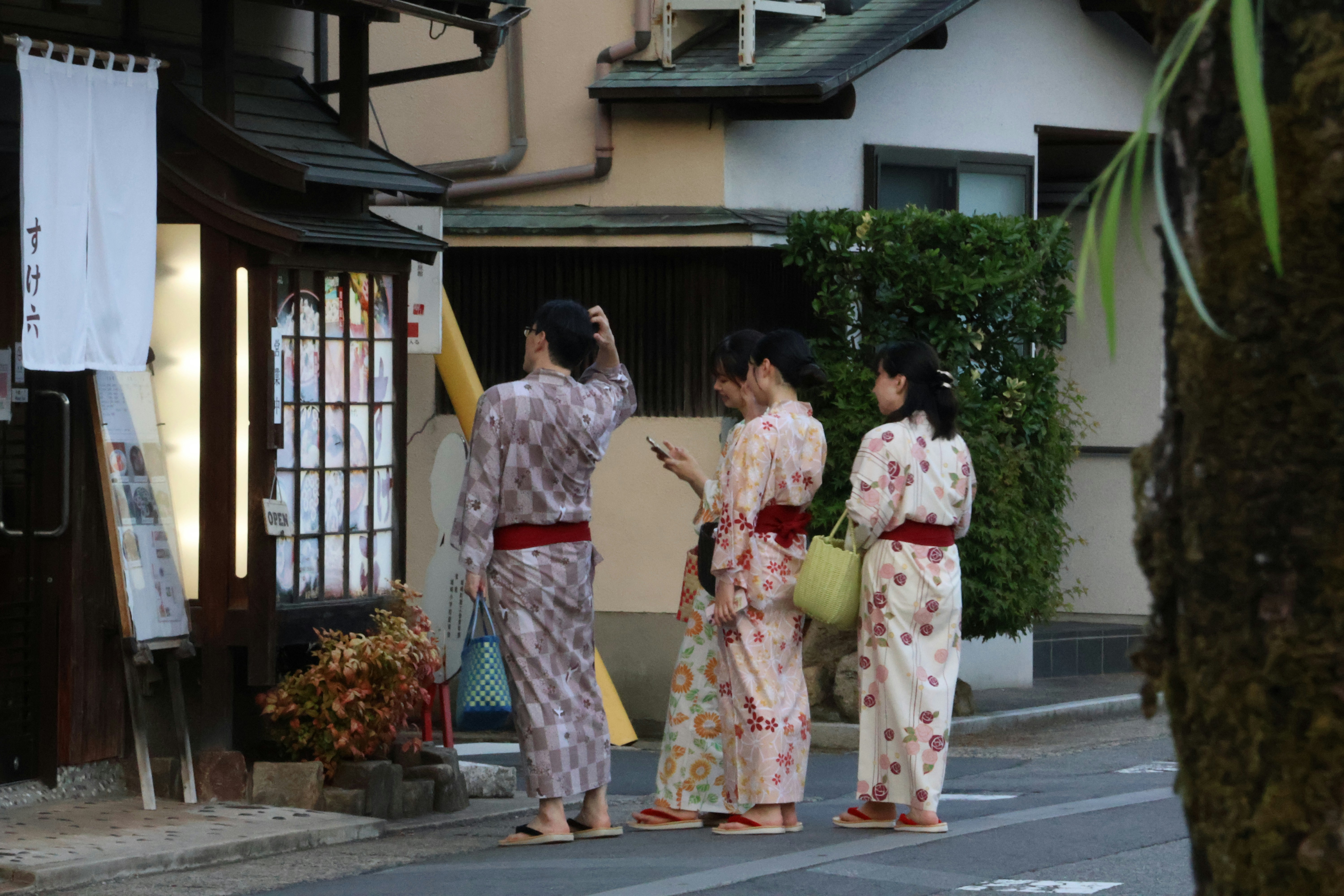 Three women in yukata walking on a street
