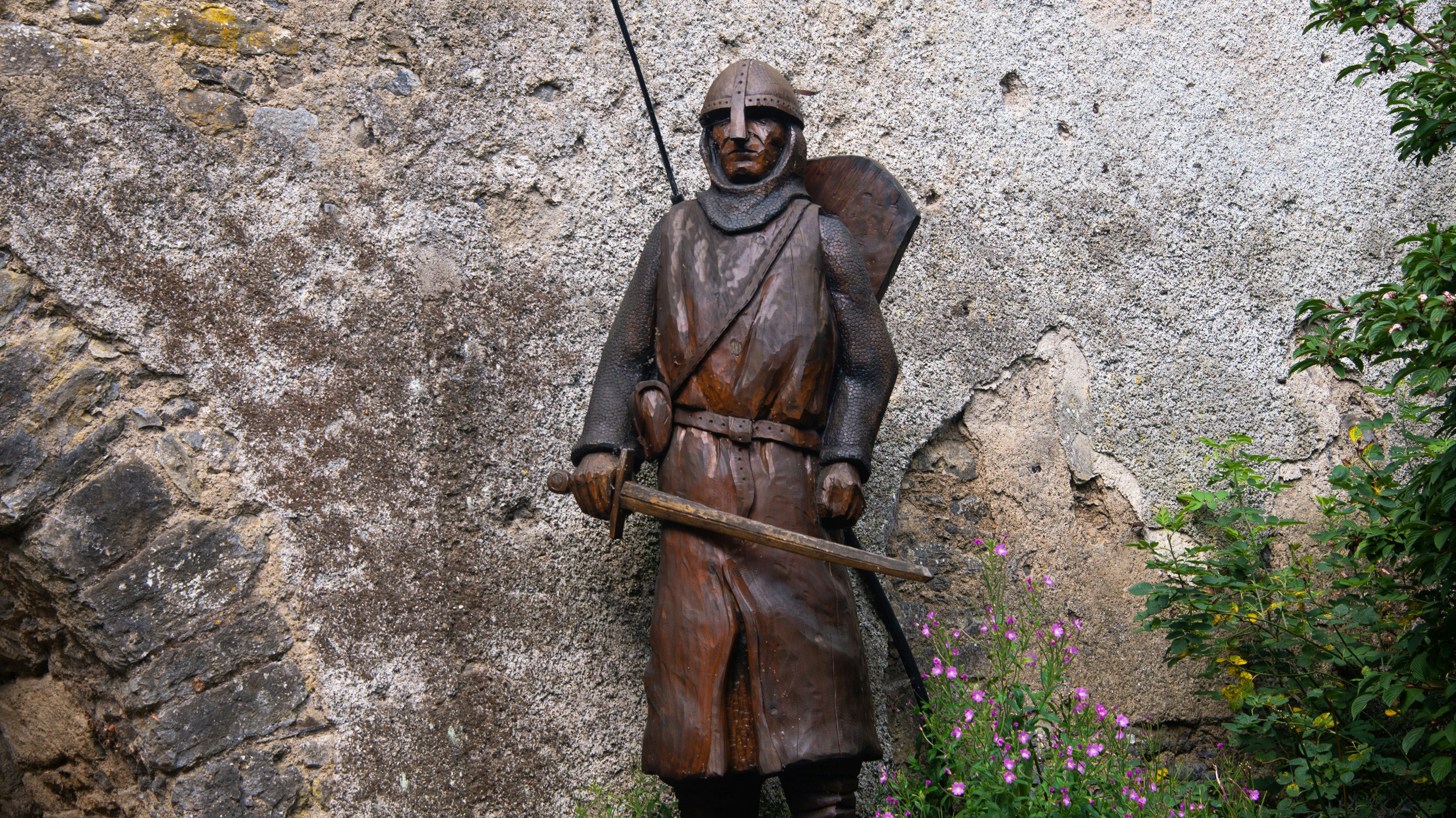 Statue of a medieval knight with sword and shield
