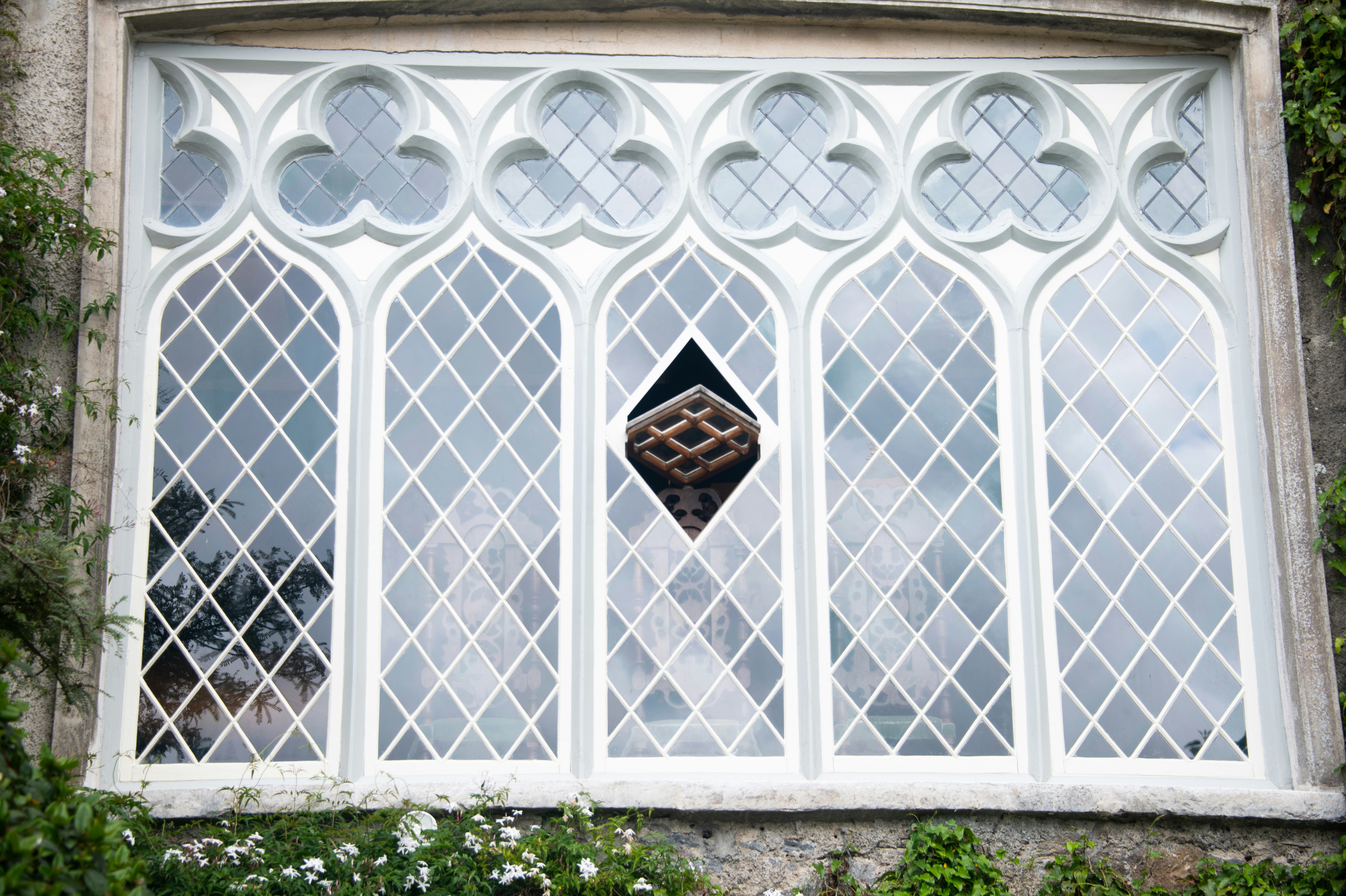 Ornate gothic window with diamond-shaped panes