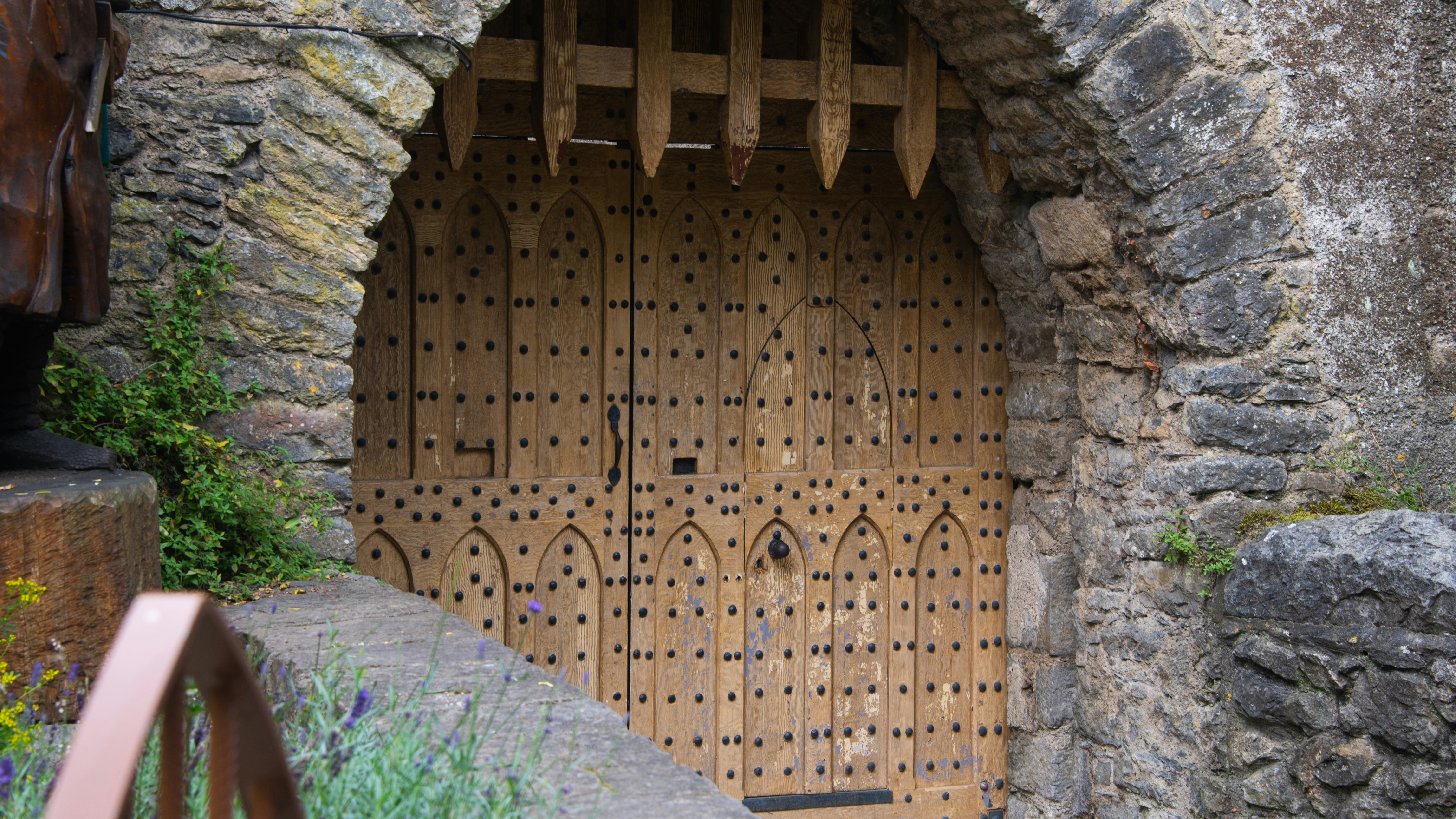 Large wooden gate set in stone archway