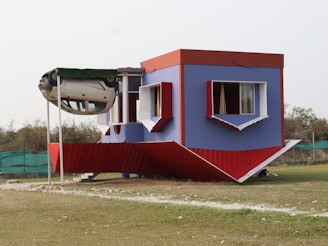An upside-down house with colorful walls and windows