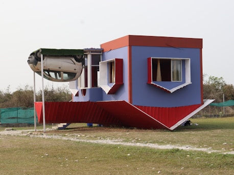 An upside-down house with colorful walls and windows
