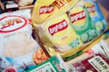 Several bags of lay's potato chips and snacks.