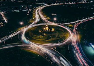 Busy roundabout with light trails at night