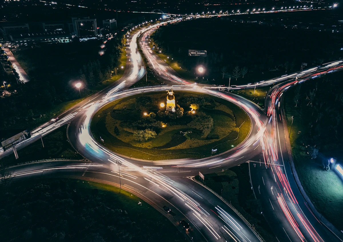 A roundabout from above with light trails