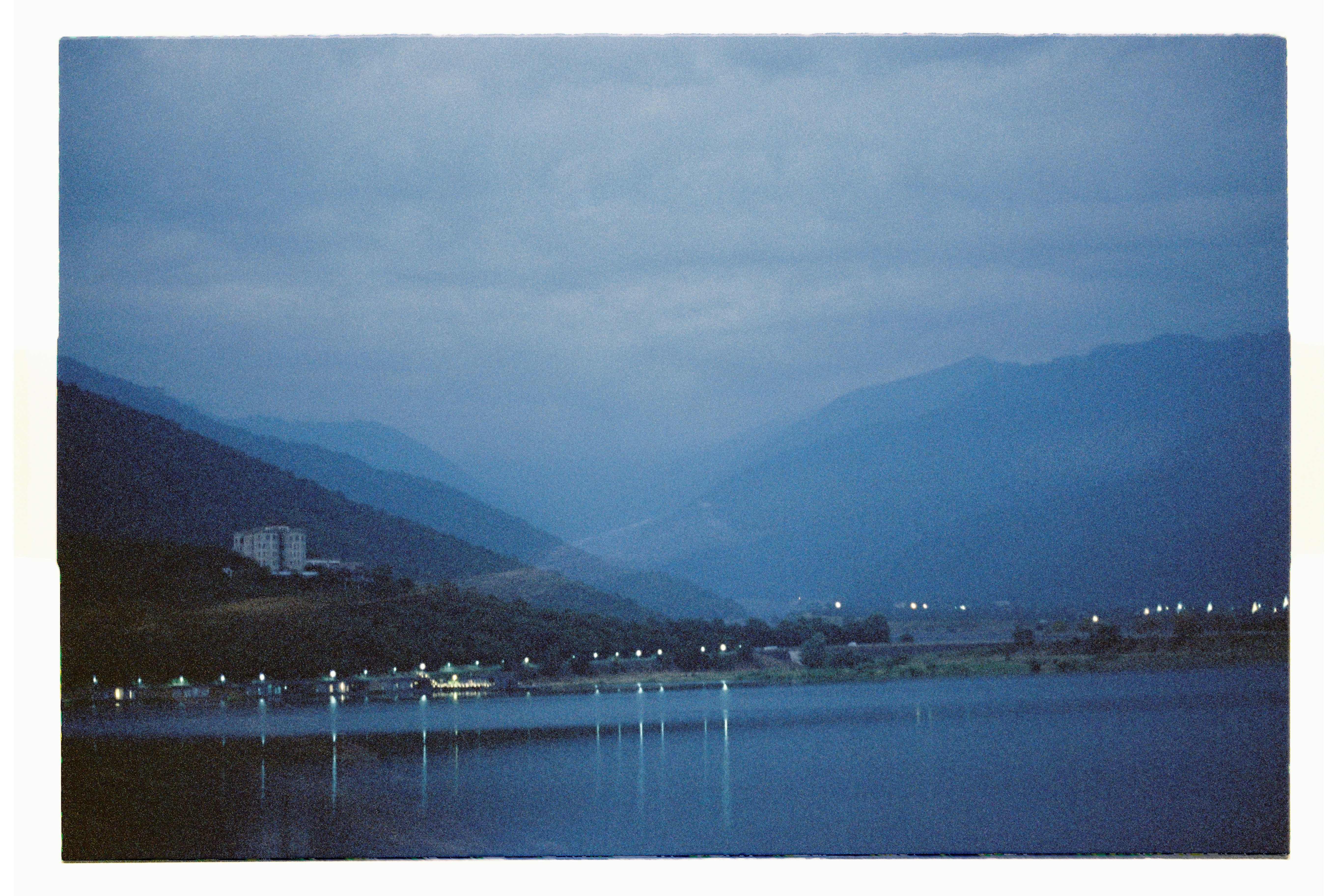 Distant mountains and a lake at dusk.