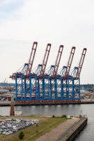 Row of large blue and red harbor cranes