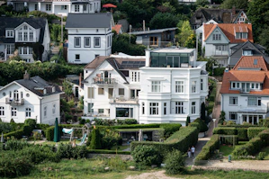 Elegant white houses on a lush green hillside