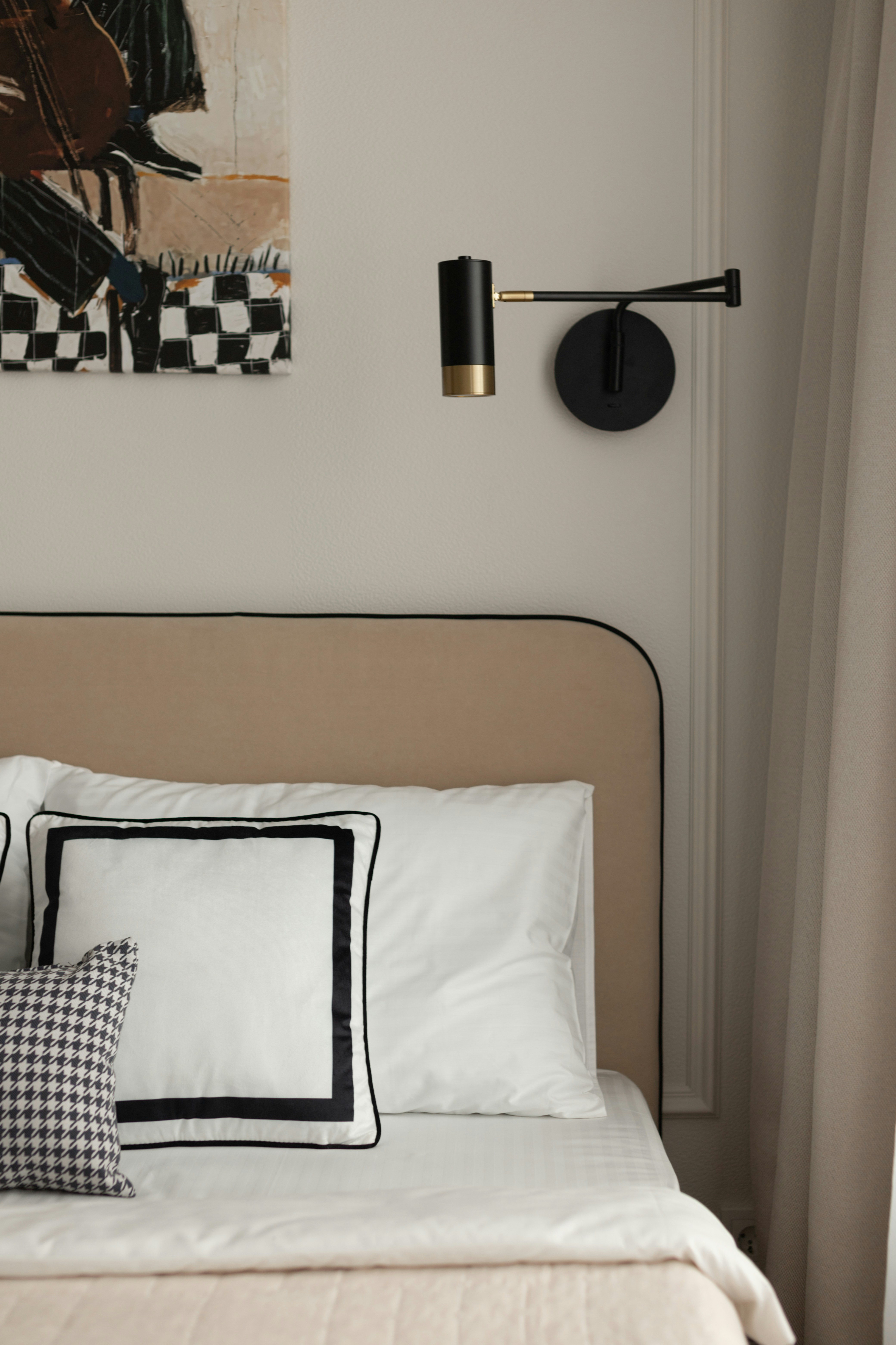 Modern bedroom with a wall lamp and pillows