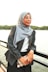 Woman in hijab and glasses by the water