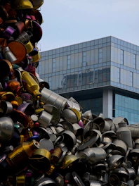 Pile of metal pots and pans with modern building